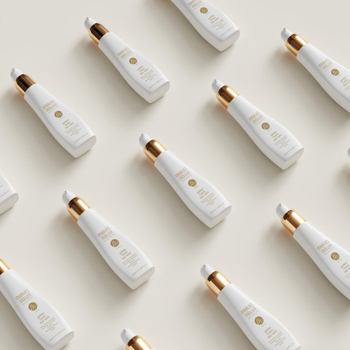 200 ml pump bottle of Golden Caviar Repair Hair Bath, amber-hued shampoo