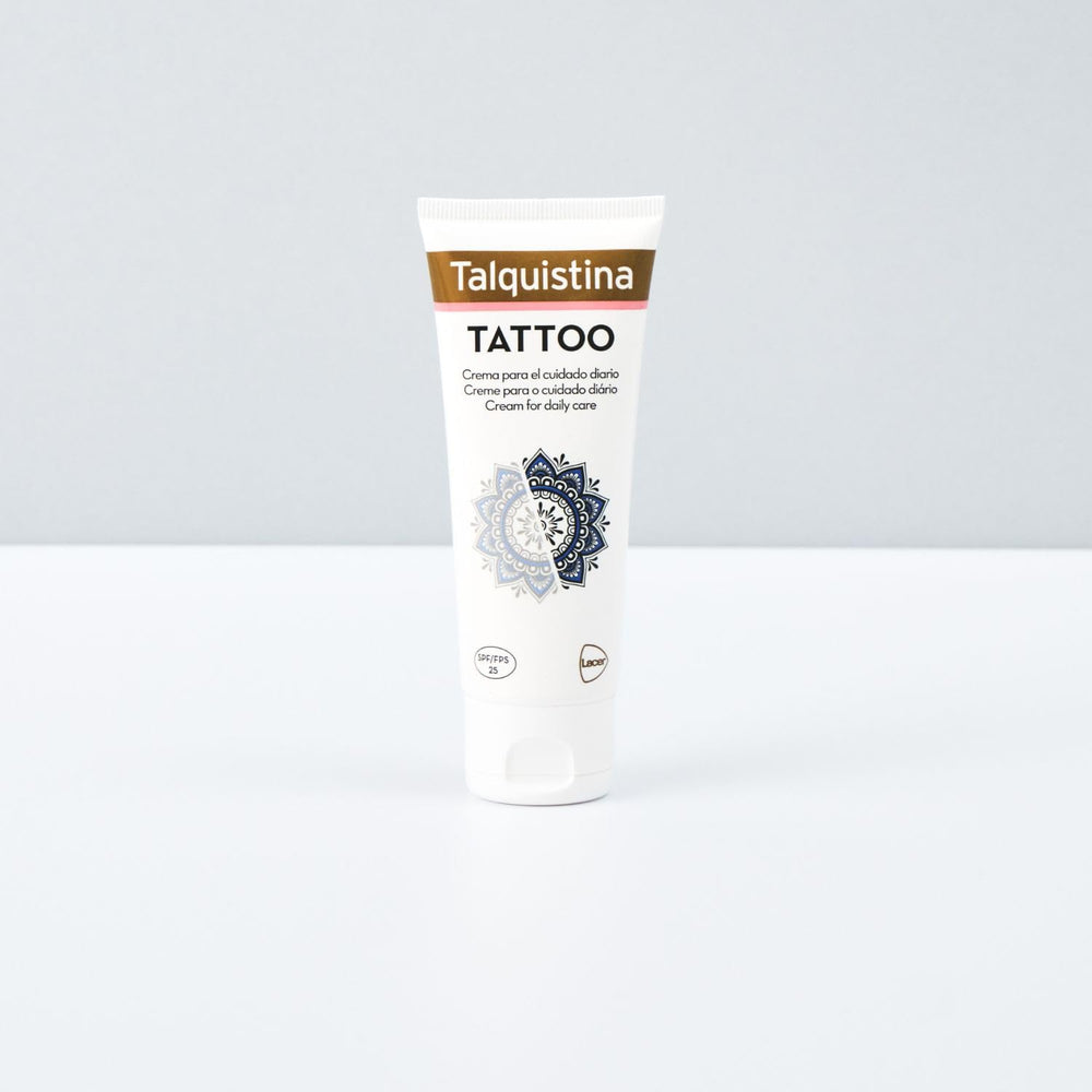 Jar of Talquistina tattoo care cream beside a tattoo sleeve, clean studio setting