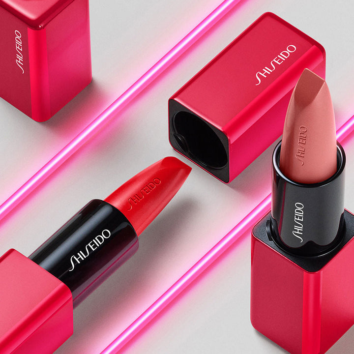 Slim bullet lipstick in muted red, contoured applicator visible, 3.3 g tube