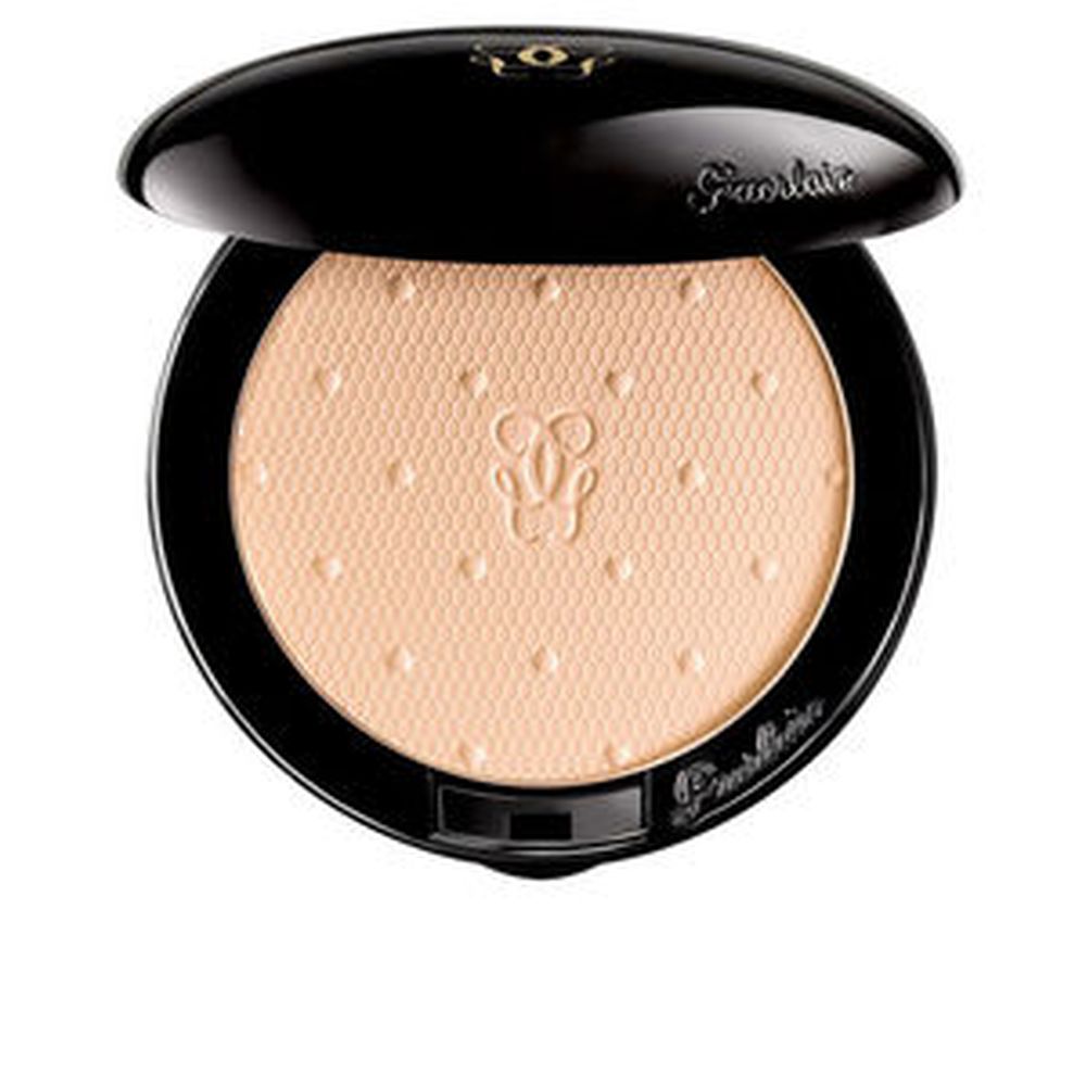 Guerlain Beige pressed face powder with hexagonal texture, embossed logo center, small raised dots, black compact