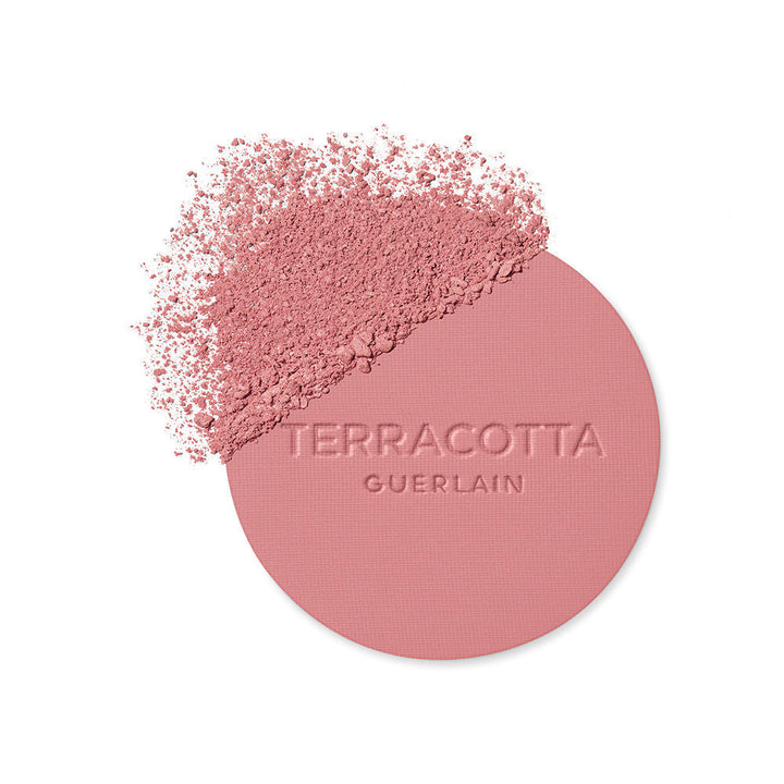 Guerlain Round glossy-lidded plastic compact showing pressed pink and brown powder blush, refined craftsmanship .