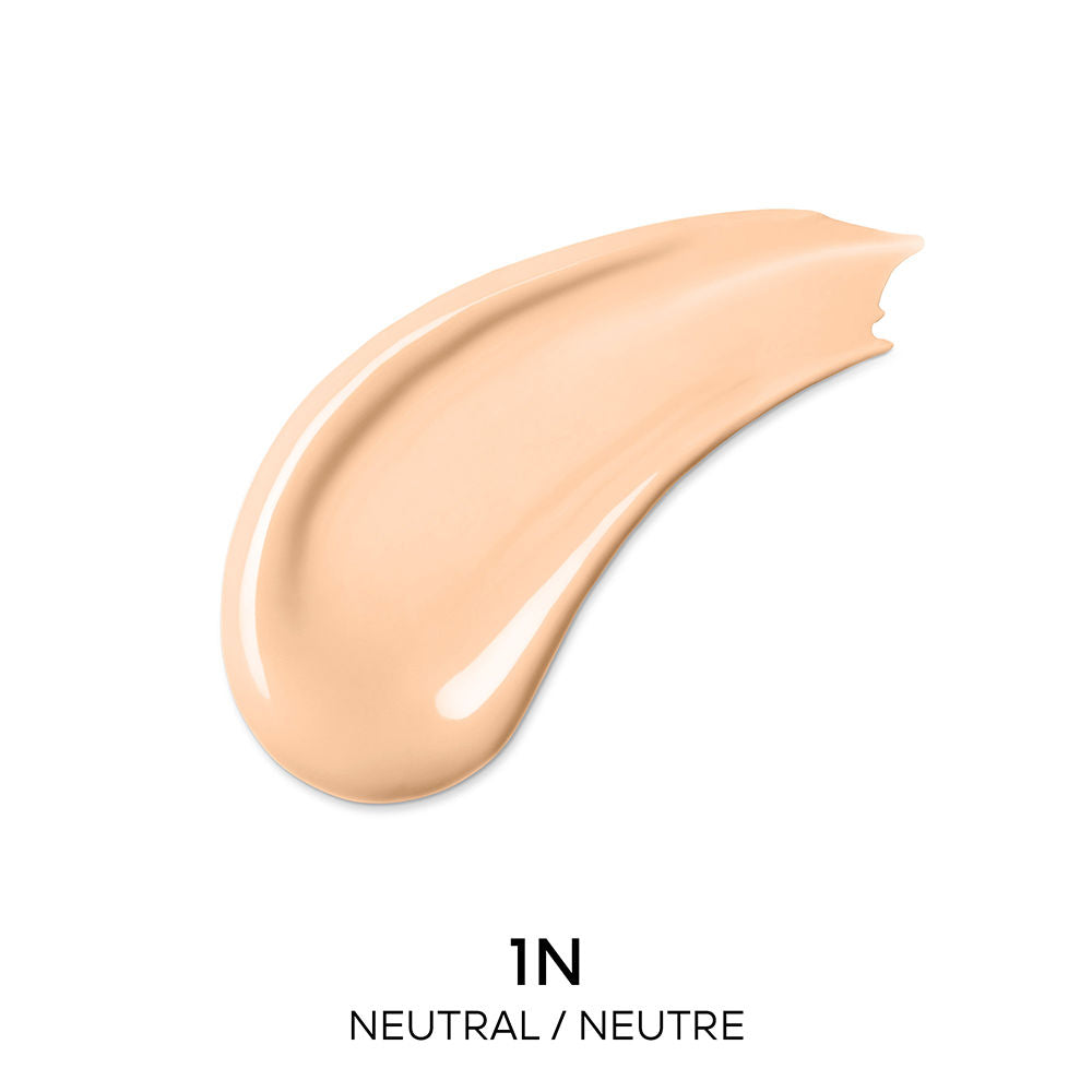 Guerlain Beige and dark brown liquid concealer in transparent cylindrical bottle with metallic cap and wand.