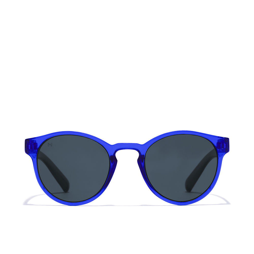 Hawkers round kids sunglasses, transparent blue plastic frame, keyhole bridge, dark round lenses