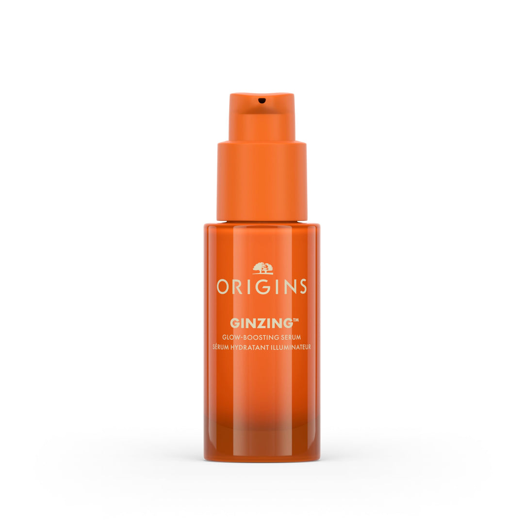 Origins Glass dropper bottle with clear orange serum, minimalist white label and silver cap