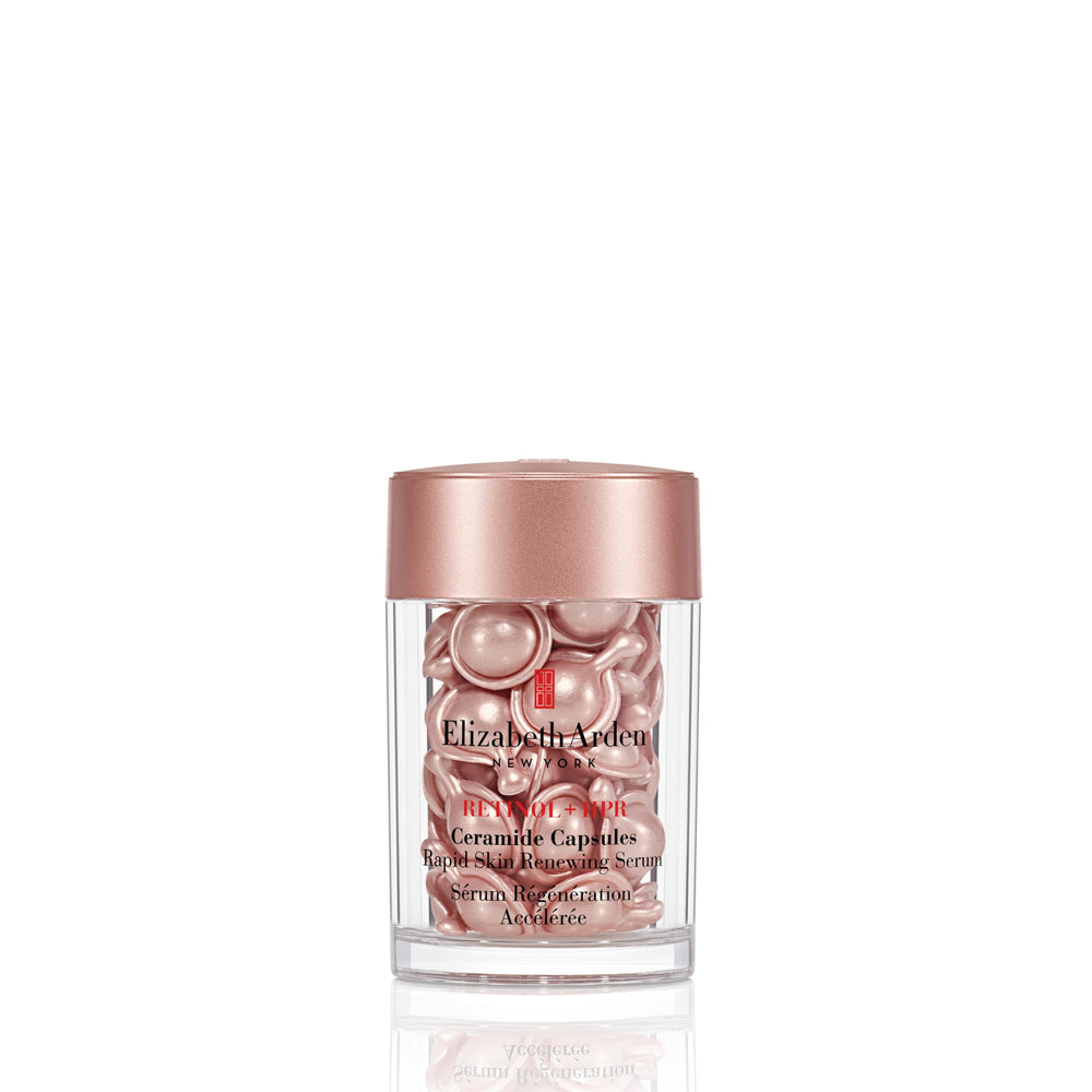 Small amber single‑dose capsule dispensed to show serum‑gel texture on finger