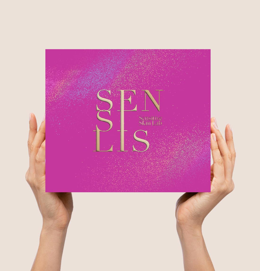 Sensilis Two pink plastic tubes with gold text and glittery packaging, transparent window revealing product names