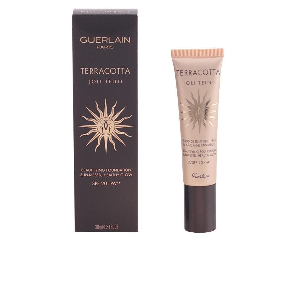 Black and beige tube with gold sun emblem, plastic tube and cardboard box, Guerlain