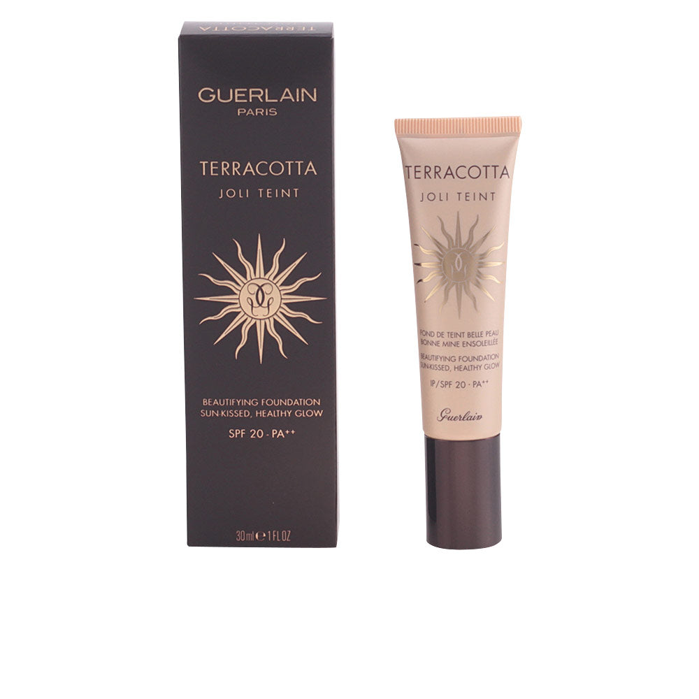 Black and beige tube with gold sun emblem, plastic tube and cardboard box, Guerlain