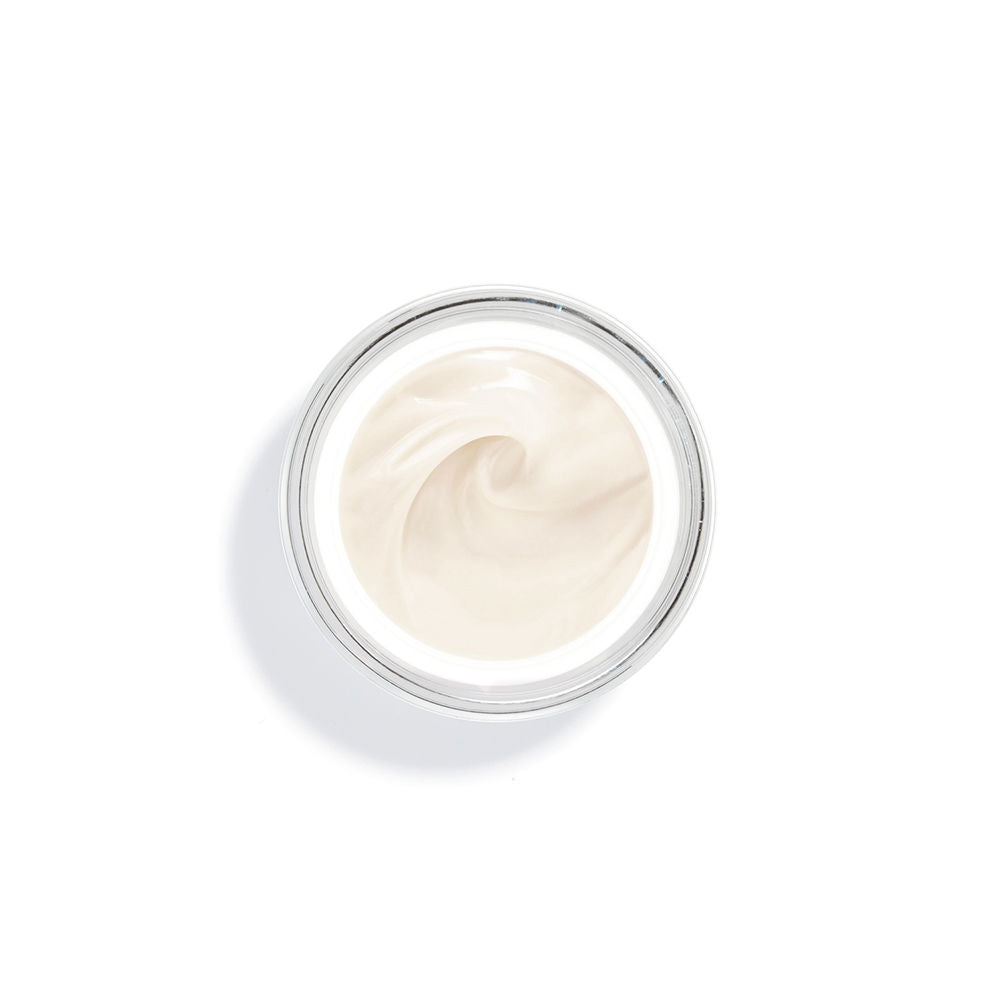 Sisley Frosted glass face cream jar with gold lid band beside square white and gold box, printed text visible