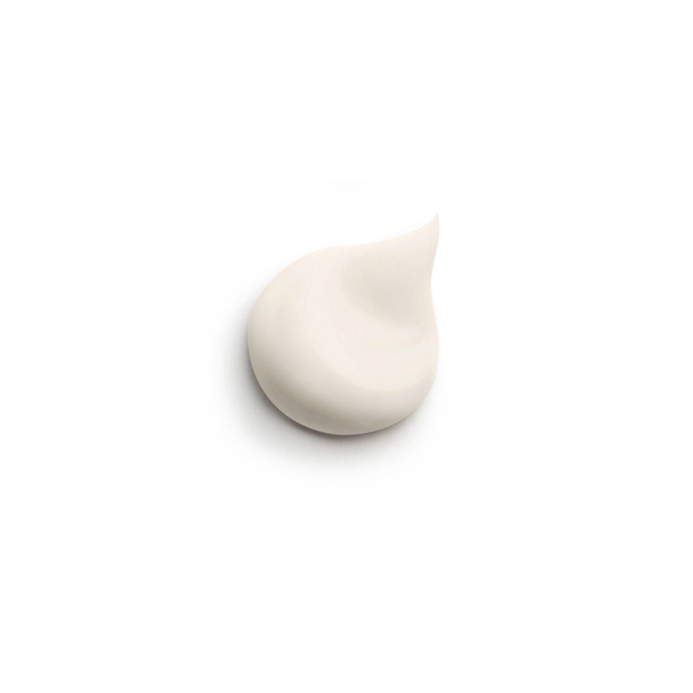 Sisley Frosted glass face cream jar with gold lid band beside square white and gold box, printed text visible