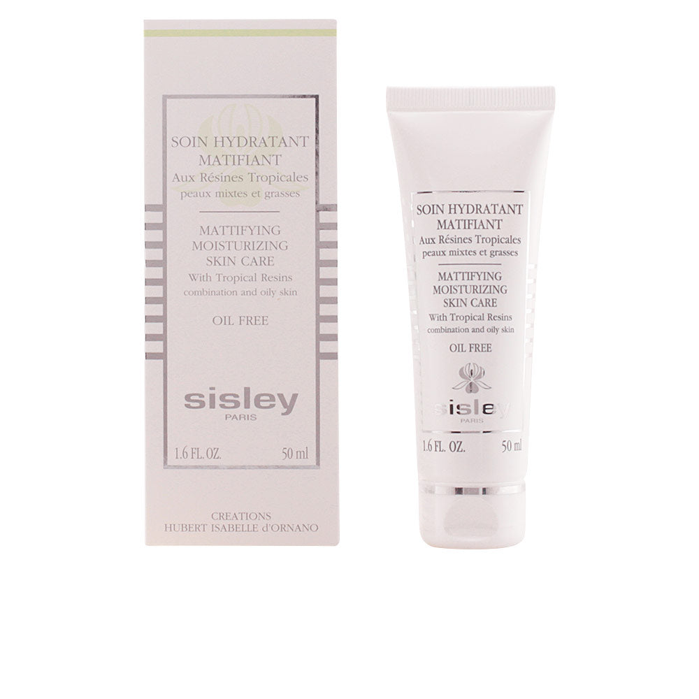 Sisley White moisturizing cream tube and box with silver accents, minimalist text print, photographed cleanly