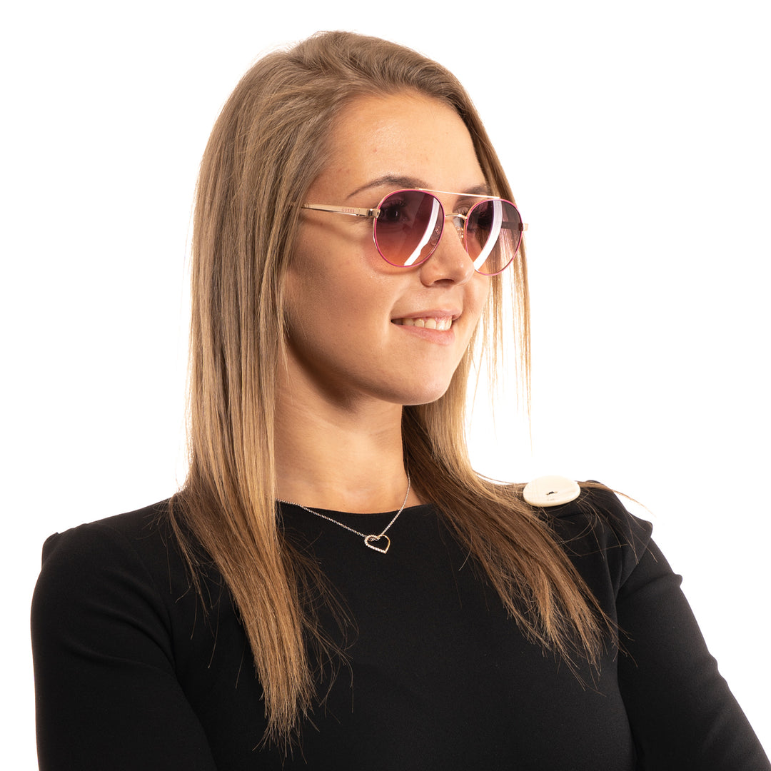 Gold metal aviator sunglasses with pink gradient lenses and double bridge on white background