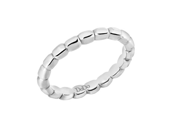 Close-up of minimalist sterling silver beaded ring showing textured beads and polished finish on a neutral background