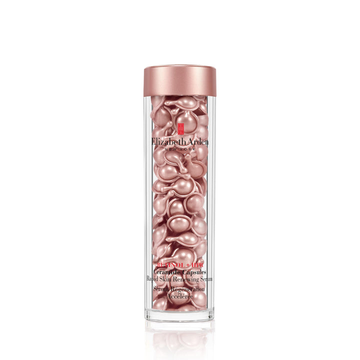 Small amber single‑dose capsule dispensed to show serum‑gel texture on finger