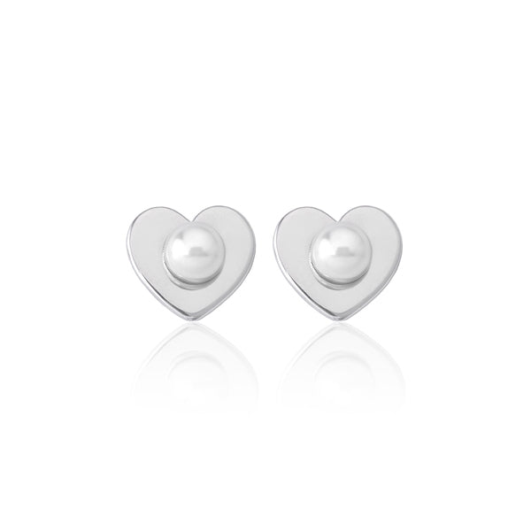 Minimalist silver heart stud earrings each centered with a small white freshwater pearl on a white background